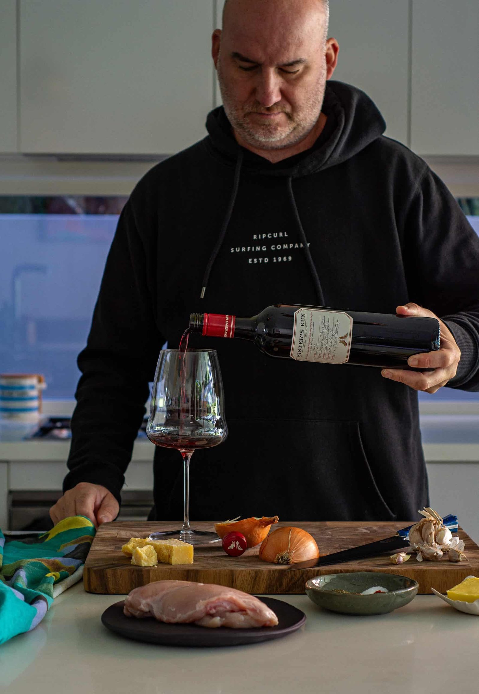 AnotherFoodBlogger pouring wine in his kitchen