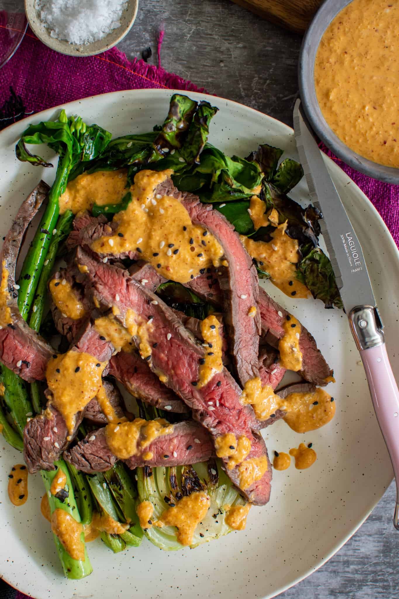 Close up view of grilled flank steak with kimchi sauce 