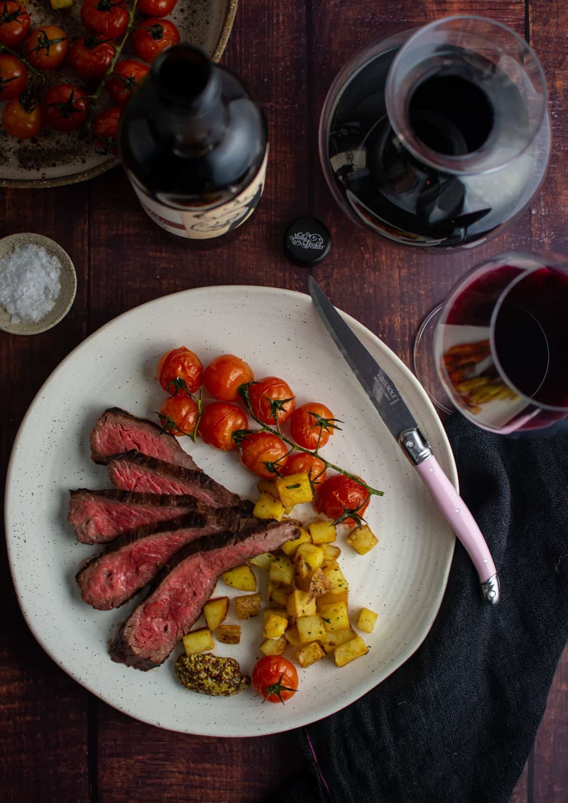 Birdseye view of steak, parmentier potatoes and roasted tomatoes